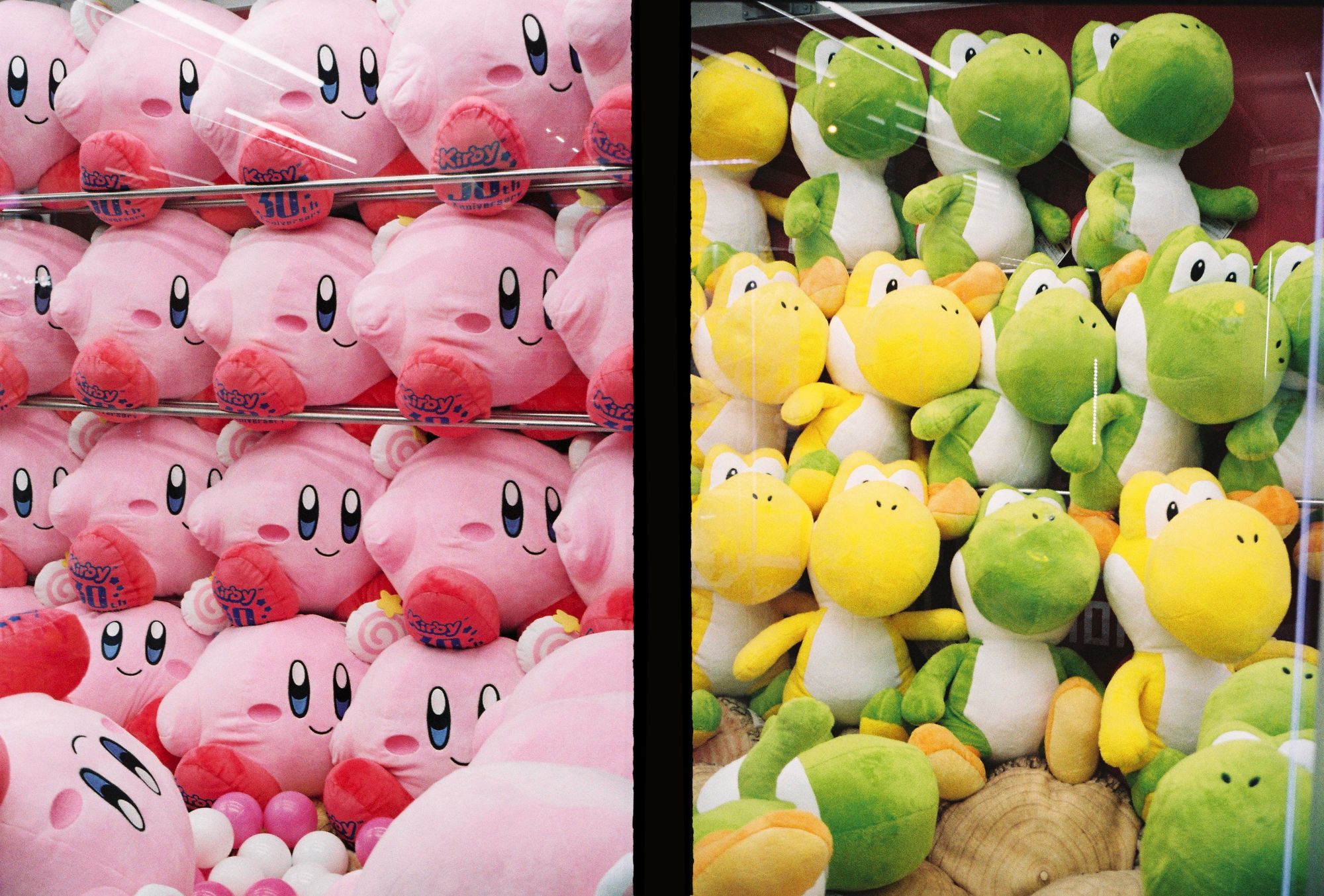 Kirby and Yoshi plushes in a Akihabara claw crane [Olympus pen ee3 sample photo, Kodak Gold]