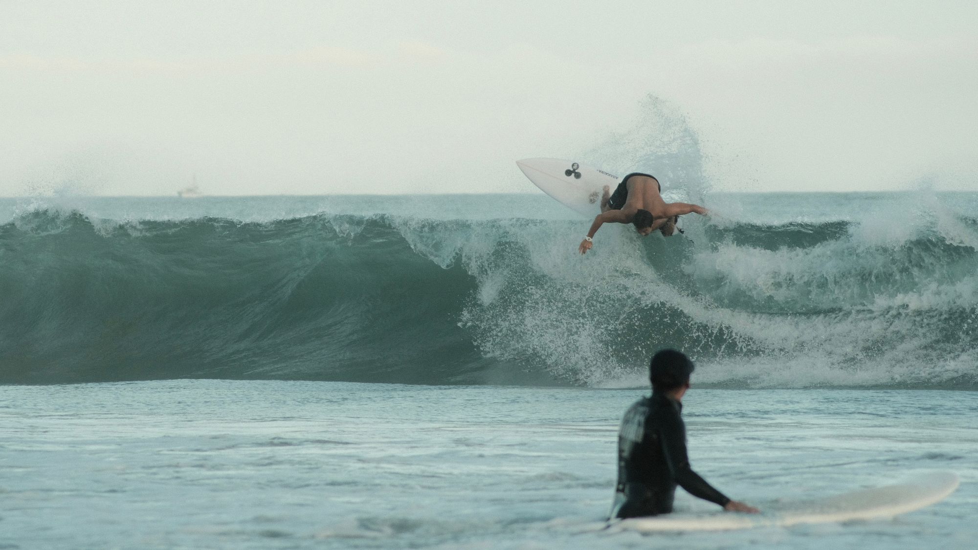 Surfer doing a top turn at golden hour in Onjuku, Japan