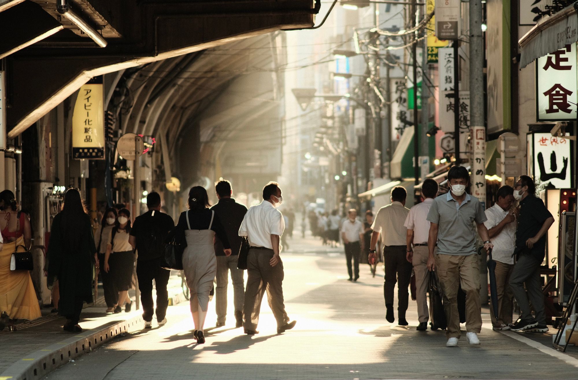 busy street scene at golden hour in tokyo