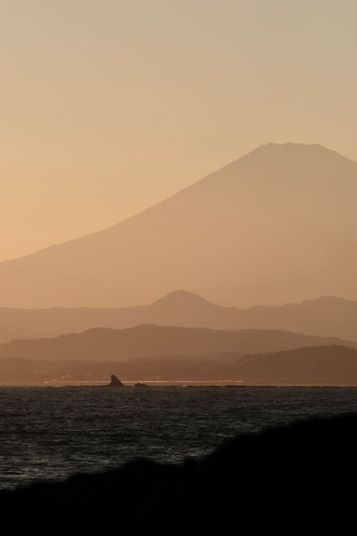 Mount Fuji in front of the ocean at sunset